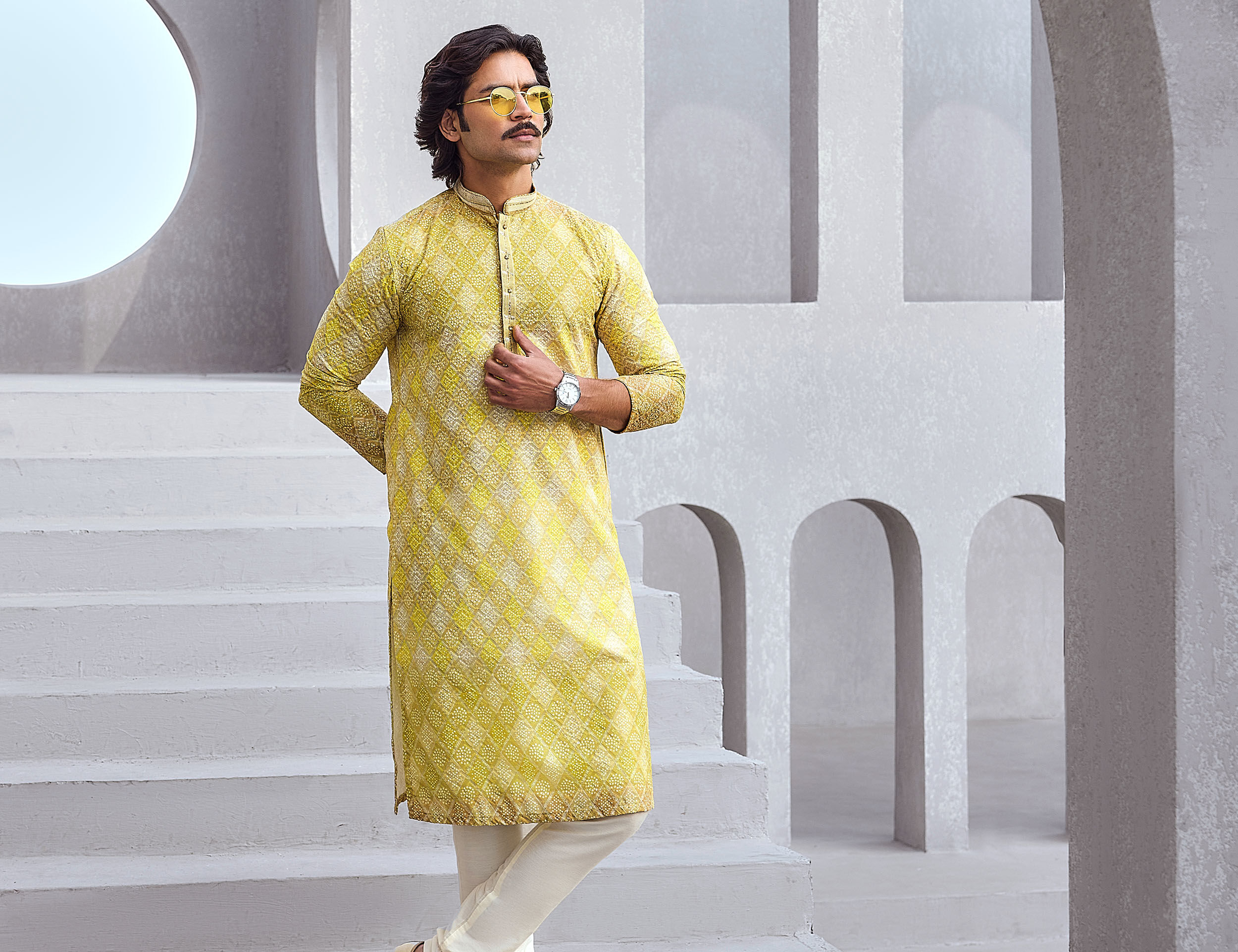 Men flaunting his elegant yellow kurta pajama